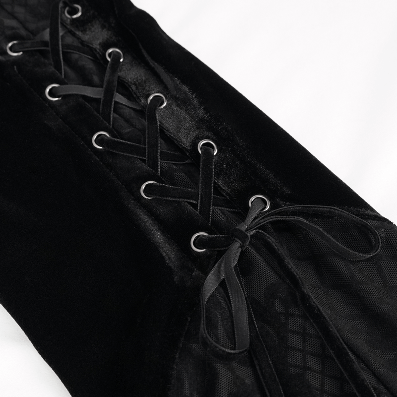 Close-up of black velvet lace-up detailing on gothic-style flared trousers, showcasing elegant design and texture.