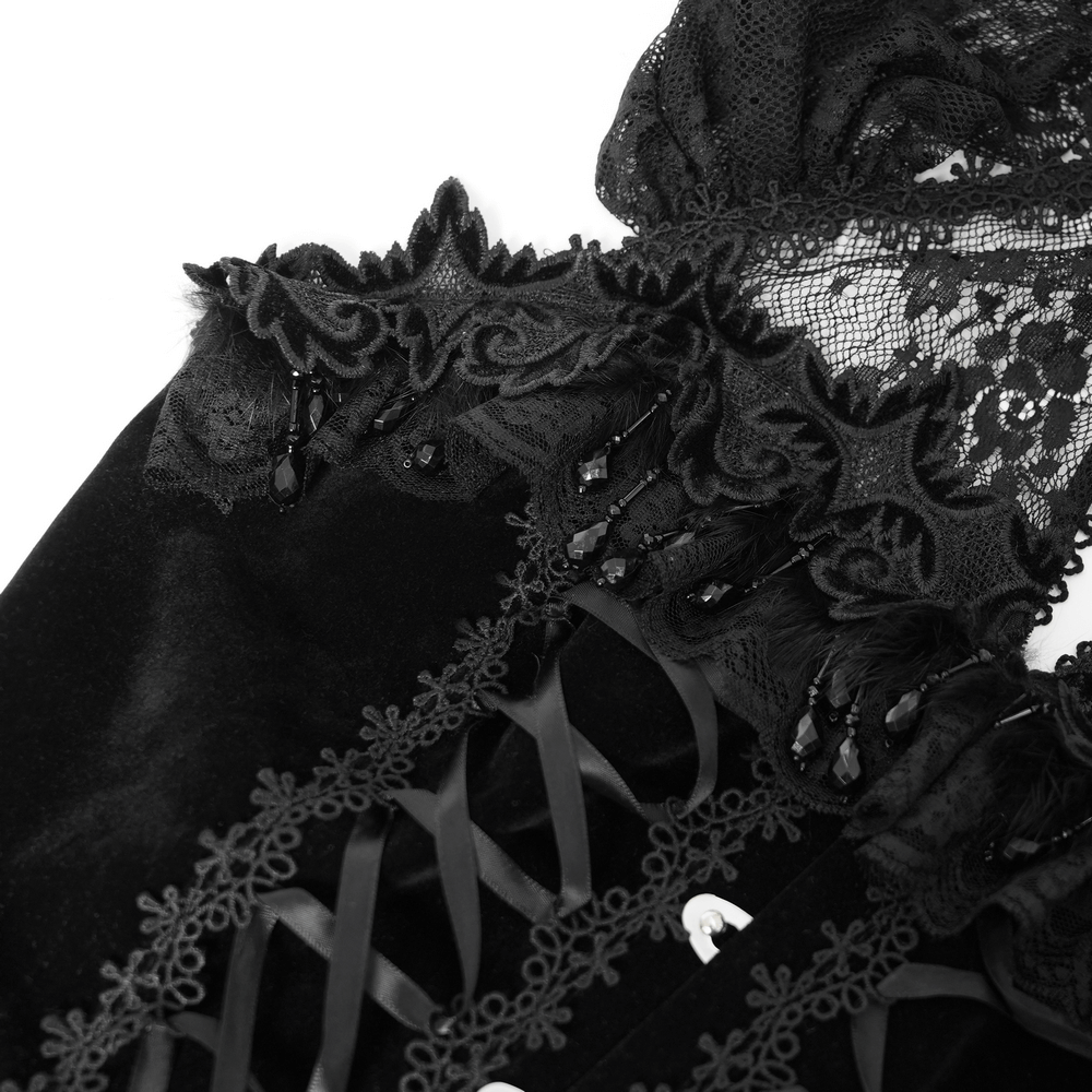 Close-up of lace detailing and corset design on a gothic black velvet maxi dress.