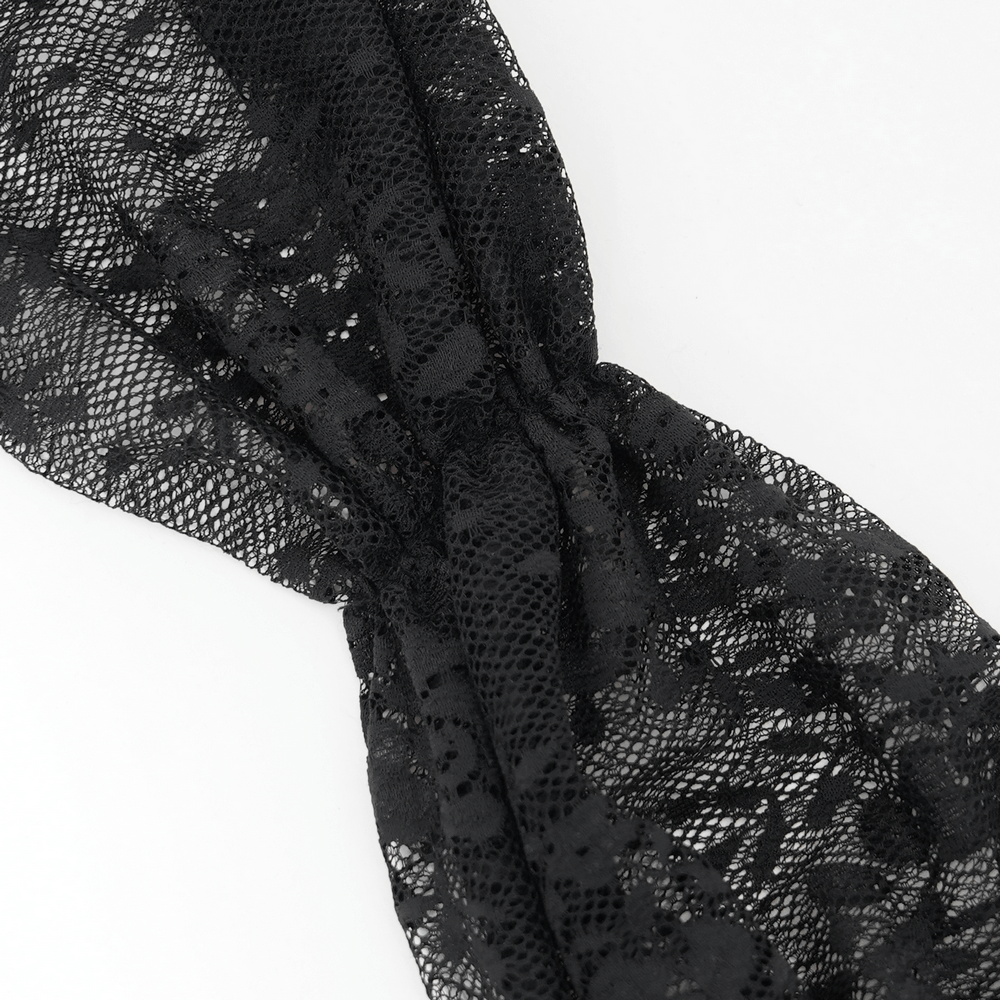 Close-up of elegant black lace fabric showcasing intricate detailing for gothic fashion.