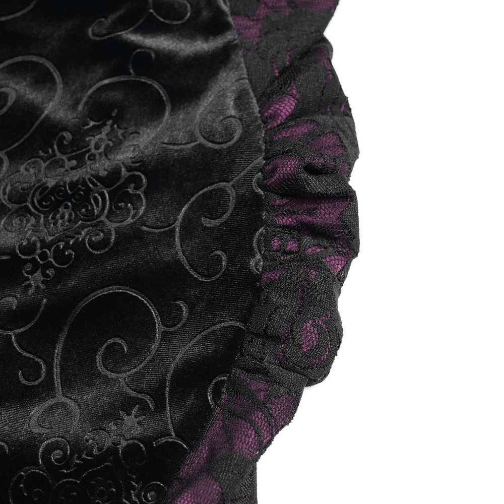 Close-up of gothic velvet fabric featuring intricate black lace and elegant purple satin ruffles.