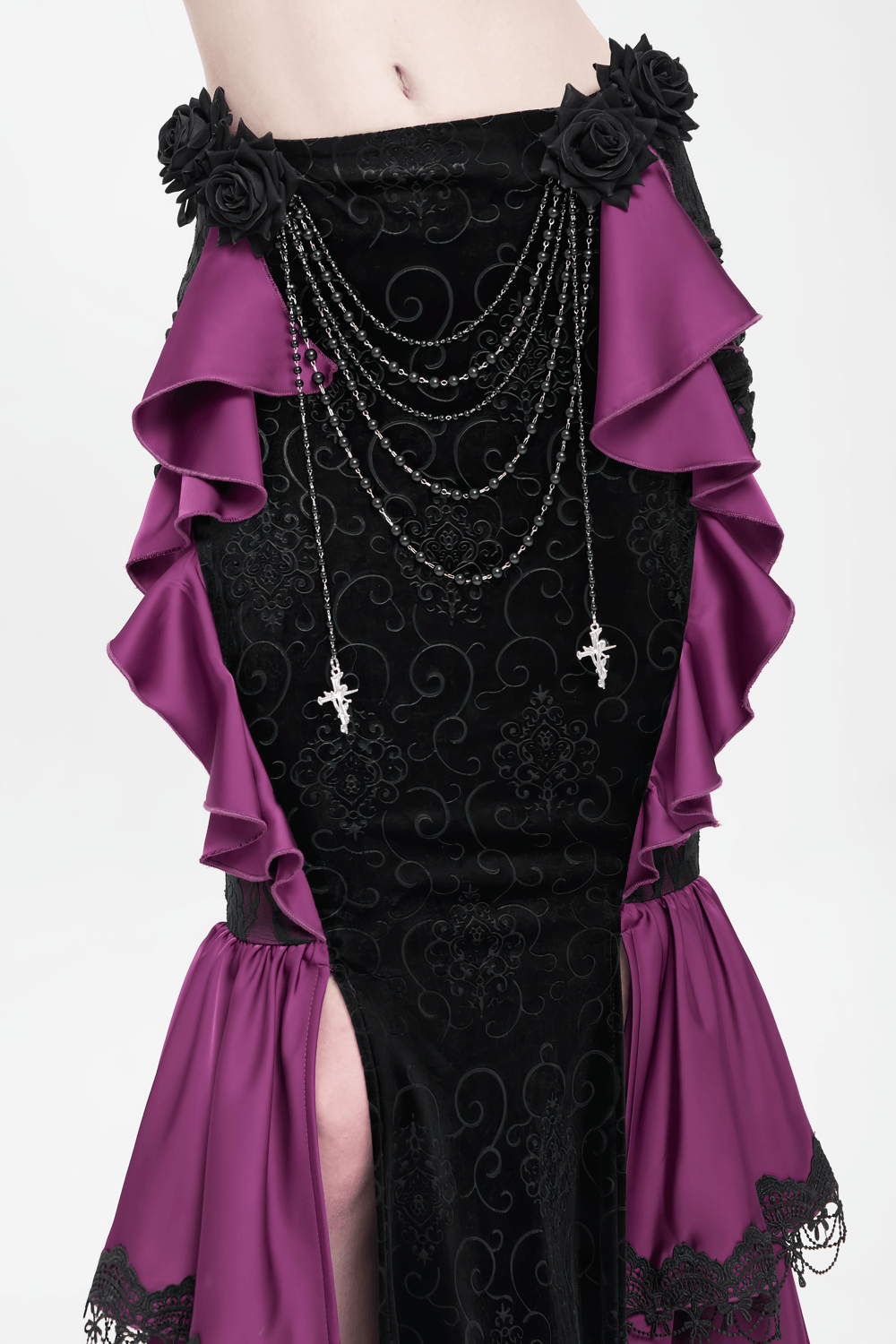 Gothic velvet maxi skirt with purple ruffles, lace roses, and layered chains for a Victorian gothic look.