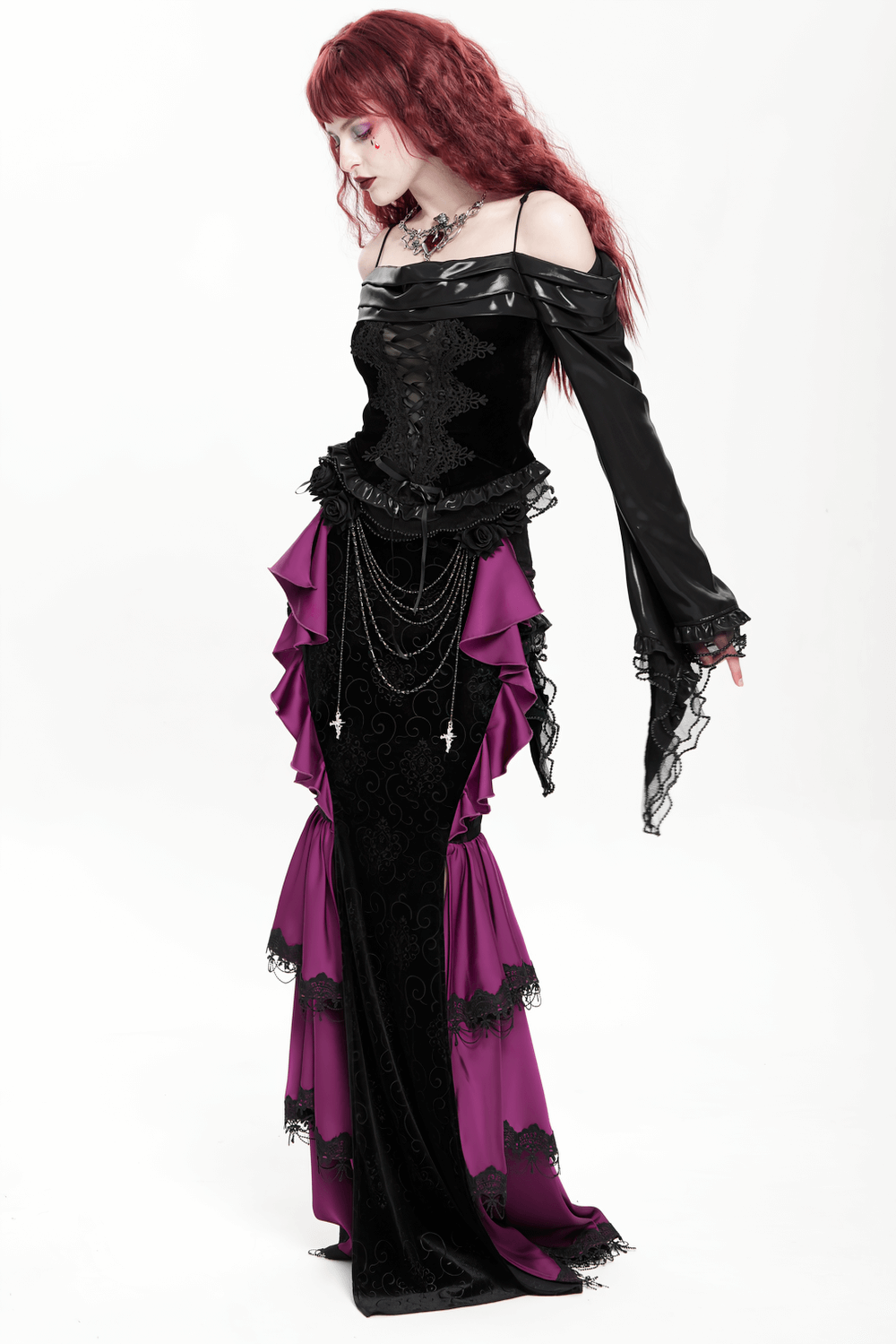 Gothic velvet maxi skirt featuring purple ruffles and chains, embodying a dramatic Victorian style with lace details.