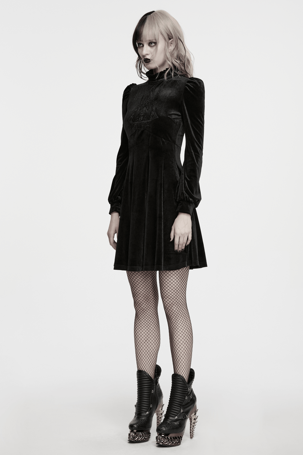 Model wearing Gothic Velvet Mini Dress with Cathedral Embroidery, showcasing its elegant design and unique style.