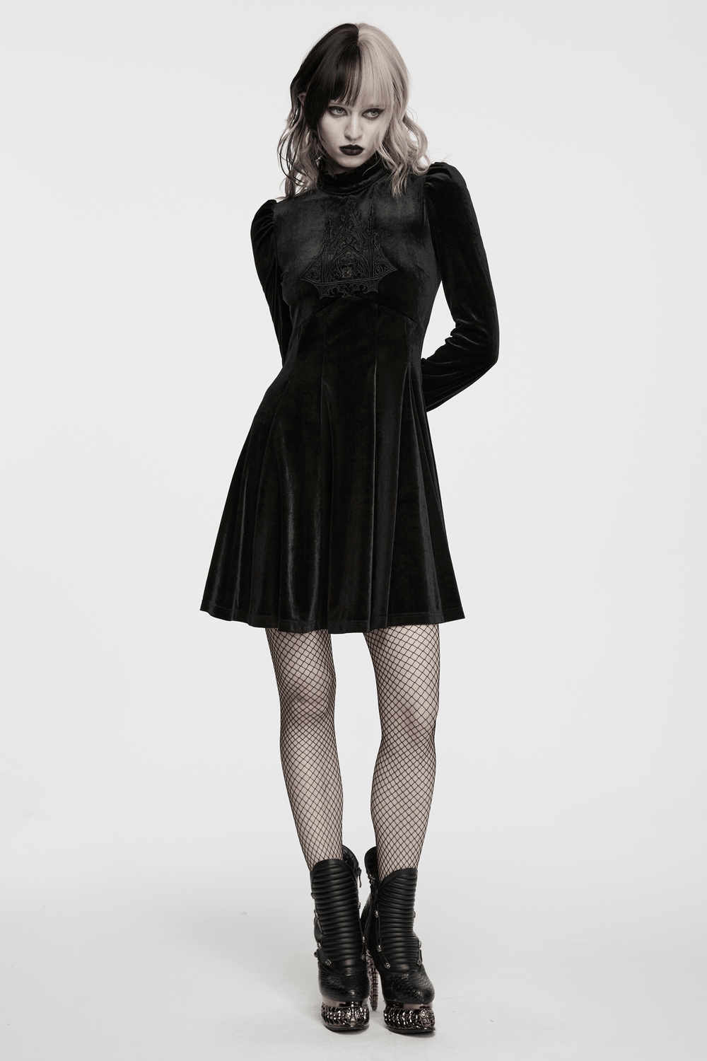Gothic Velvet Mini Dress with Cathedral Embroidery showcased by a model in dramatic black and stylish footwear.