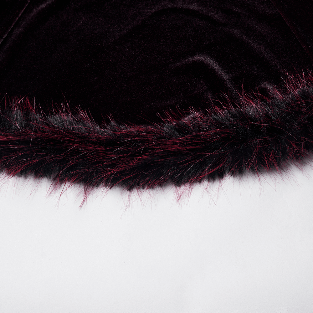 Close-up of the feather trim in rich burgundy and black on a luxurious velvet fabric.