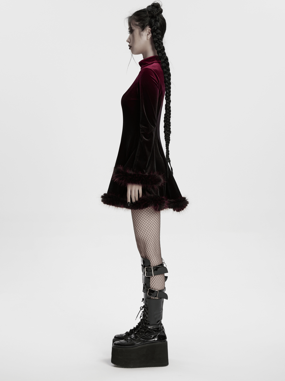 Gothic velvet mini dress with feather trim, showcasing rich gradient design and stylish fishnet stockings.