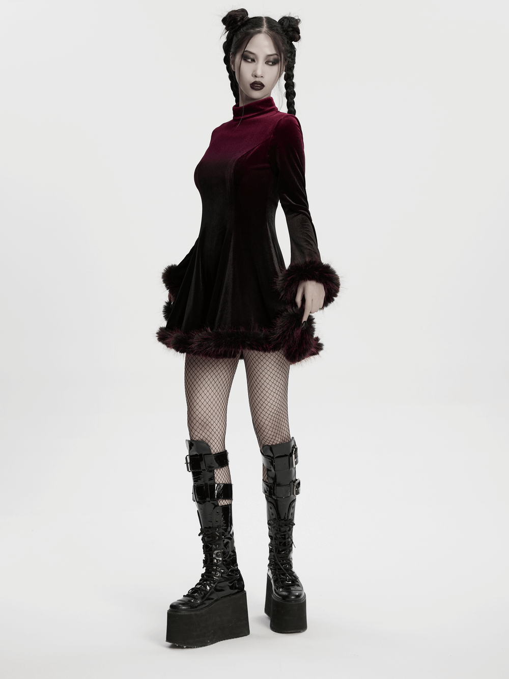 Gothic velvet mini dress with feather trim, featuring a model in platform boots and fishnet stockings.