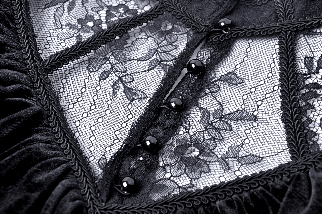 Close-up of black velvet mini dress with floral lace and decorative buttons, showcasing gothic Victorian elegance.