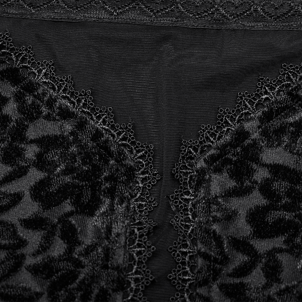 Close-up of gothic black lace and velvet fabric, featuring intricate floral mesh and heart-shaped lace edging.