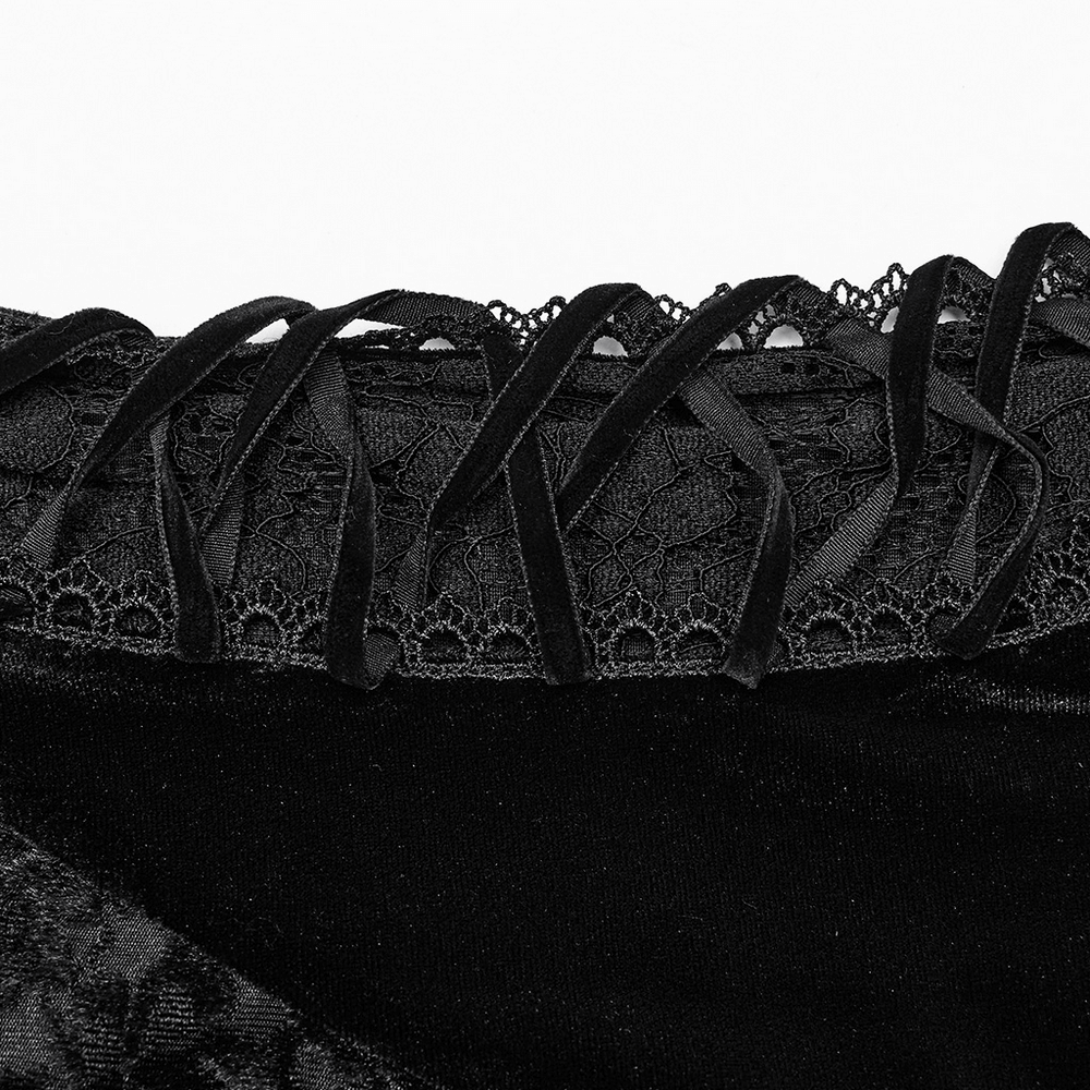 Close-up of gothic velvet dress showing intricate heart-shaped lace and ribbon detailing.