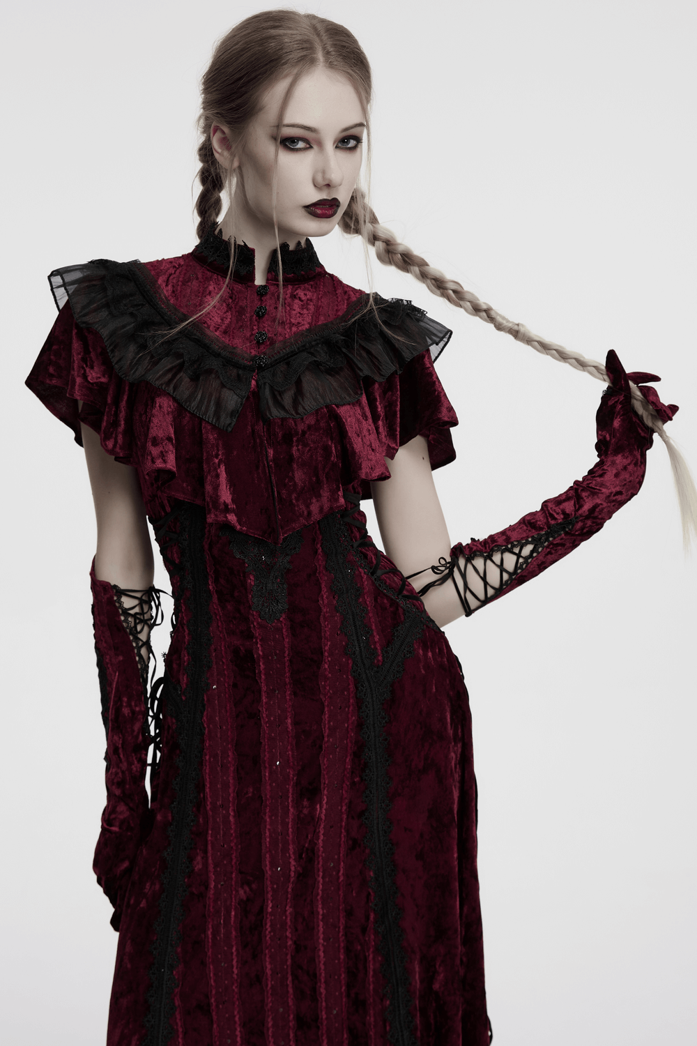 Gothic velvet opera gloves with lace embroidery worn by model in dramatic red dress, showcasing vintage flair and elegance.