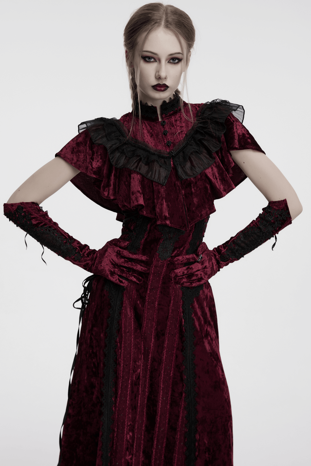 Gothic velvet opera gloves with lace embroidery worn by model in elegant dark dress for dramatic vintage style.