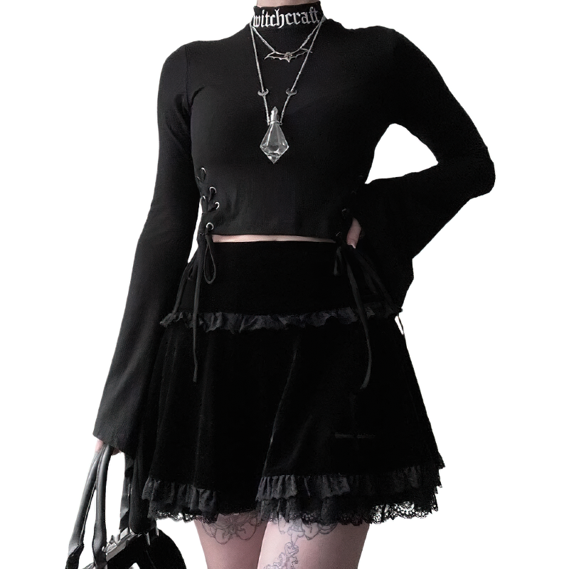Gothic velvet pleated mini skirt with lace ruffles styled with a black crop top and accessories for women.
