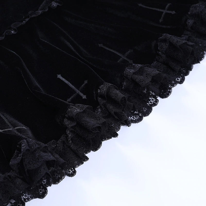 Close-up of gothic velvet mini skirt with lace ruffles and cross embroidery details, perfect for edgy style.