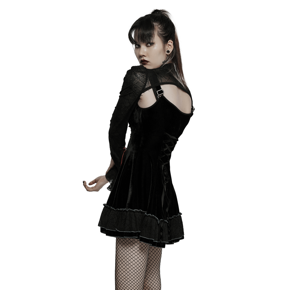 Gothic velvet dress set showcasing a model in a black short coat and matching spider web slip dress with playful details.