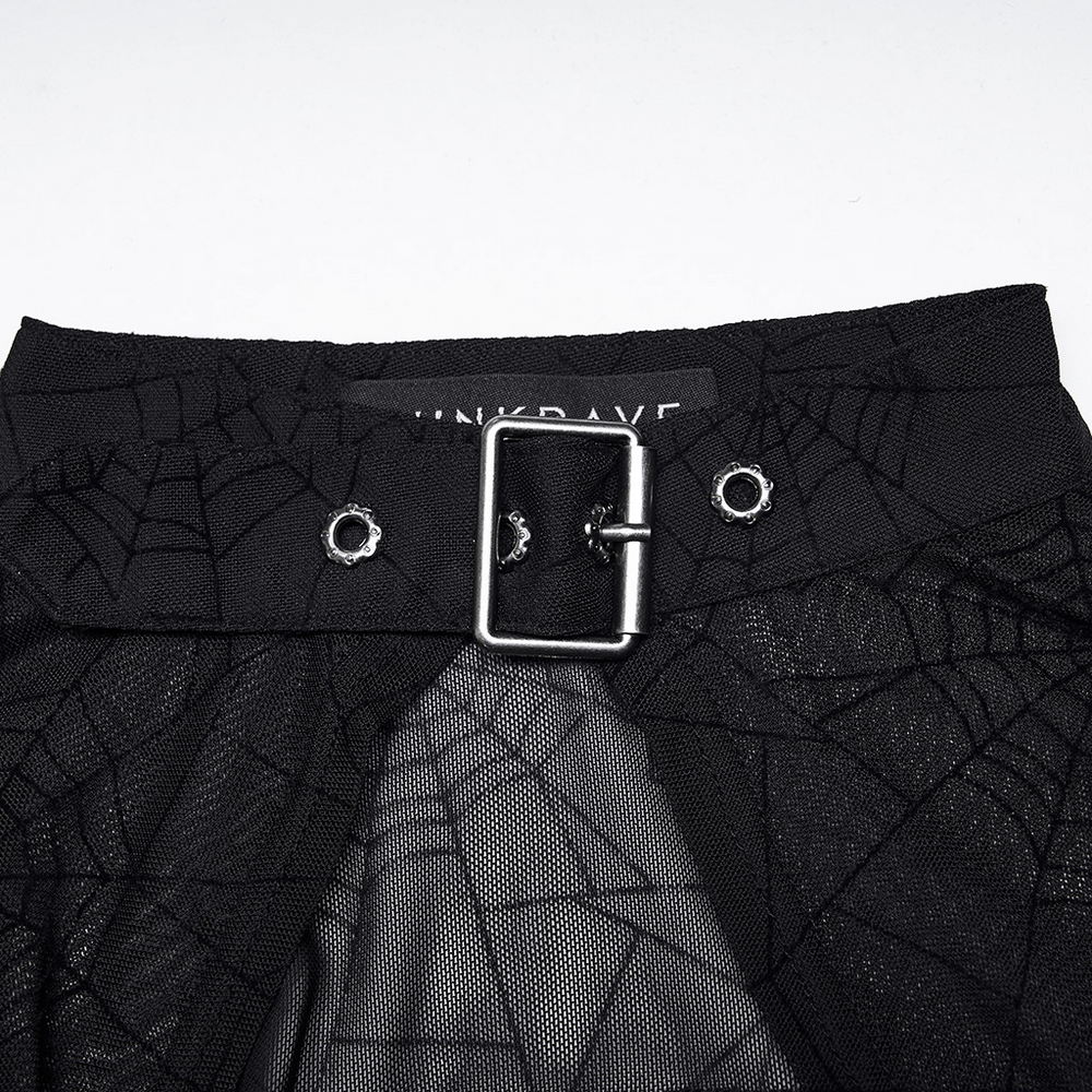 Close-up of a Gothic-inspired black skirt featuring spider web design and metallic buckle details.