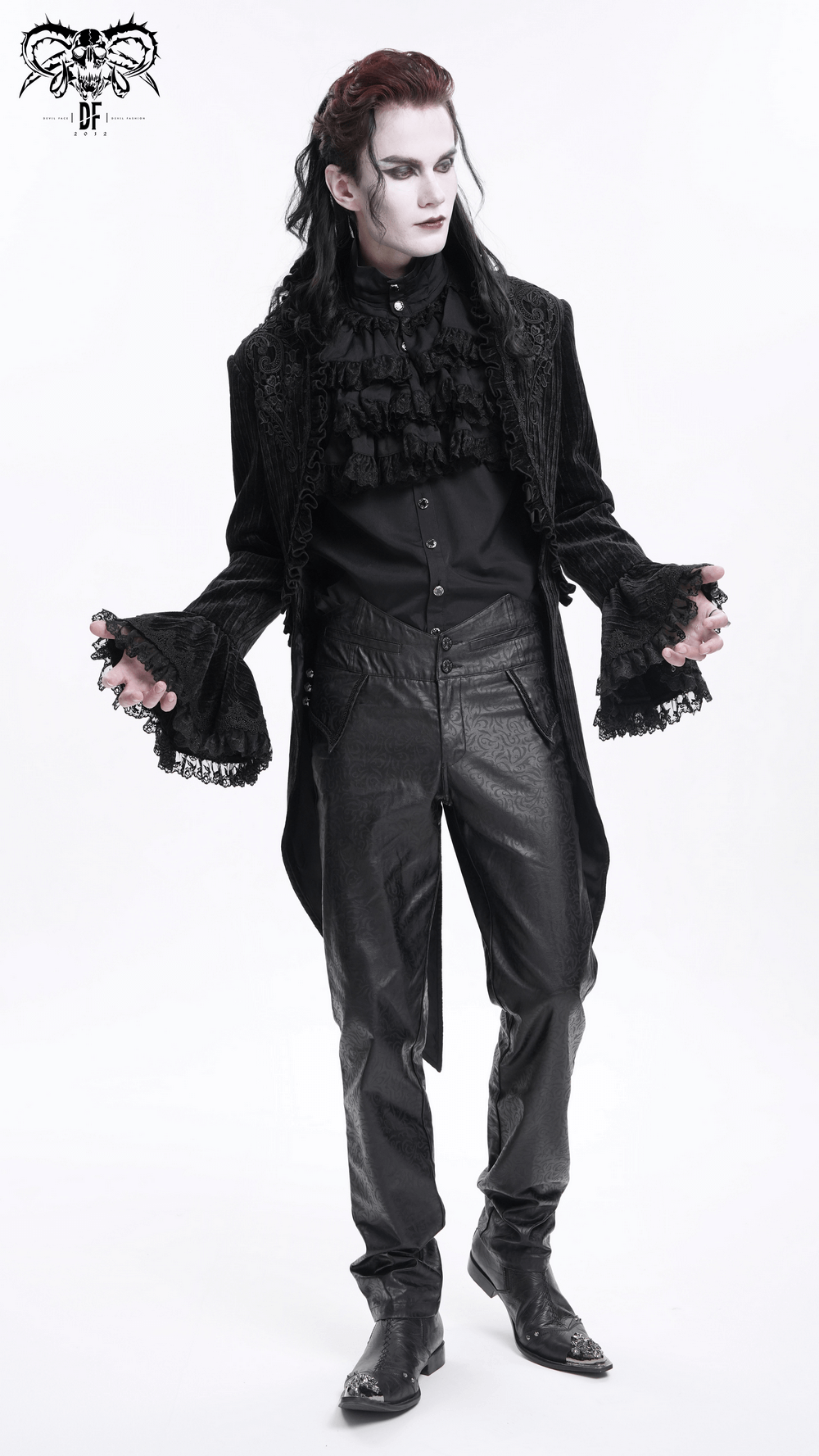 Gothic velvet swallowtail jacket with lace detailing worn by model, paired with tailored trousers for a darkly stylish look.