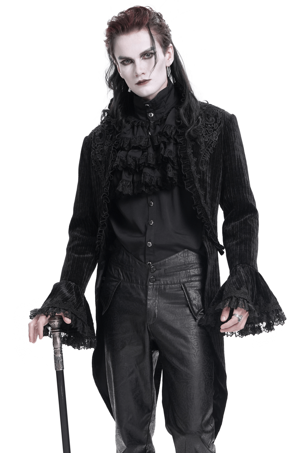 Model wearing a gothic velvet swallowtail jacket with embroidered trim, flaunting dark elegance and Victorian flair.