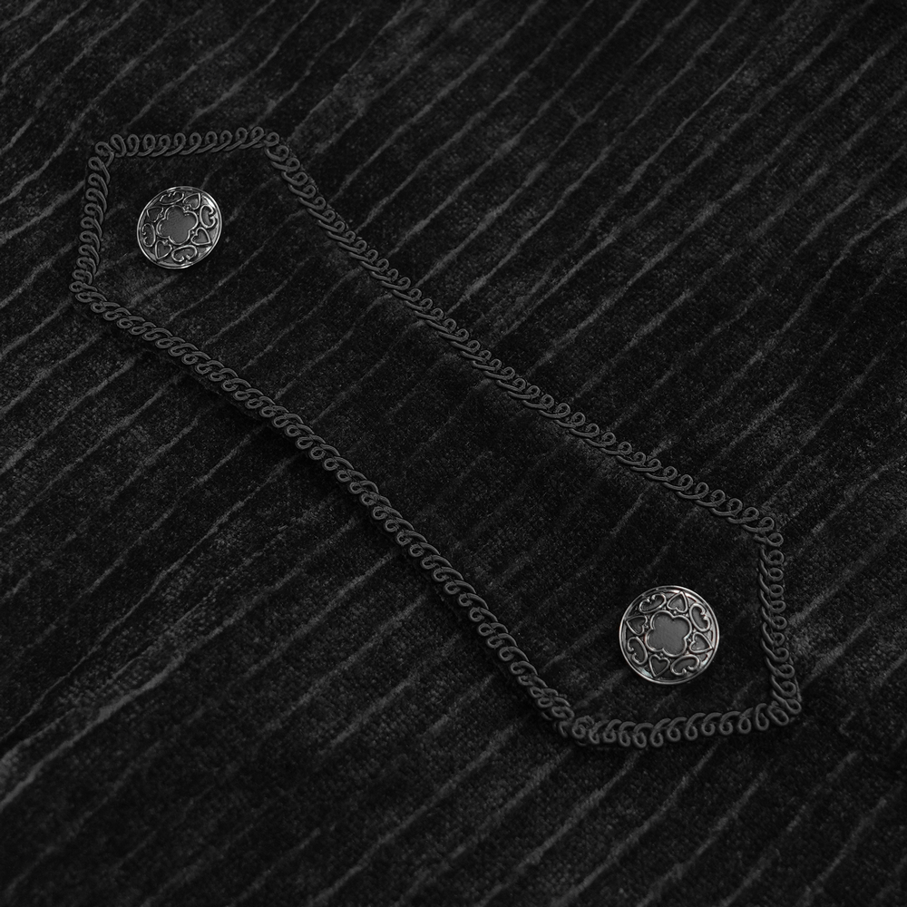 Close-up of ornate silver buttons and lace trim on a men's gothic black velvet swallowtail jacket.