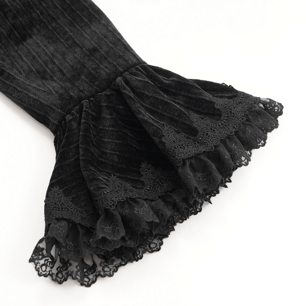 Flared cuffs of a black velvet gothic tailcoat featuring intricate lace detailing for a dramatic touch.