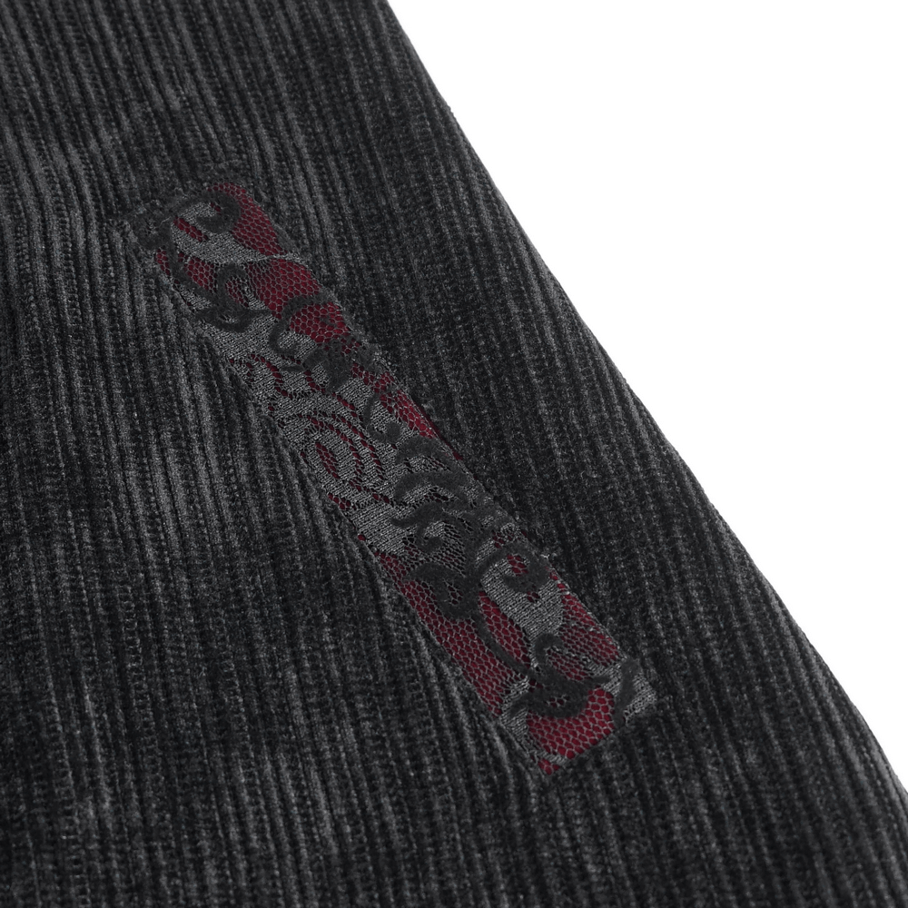 Close-up of black velvet fabric with intricate embroidered details on men's gothic velvet tailcoat.