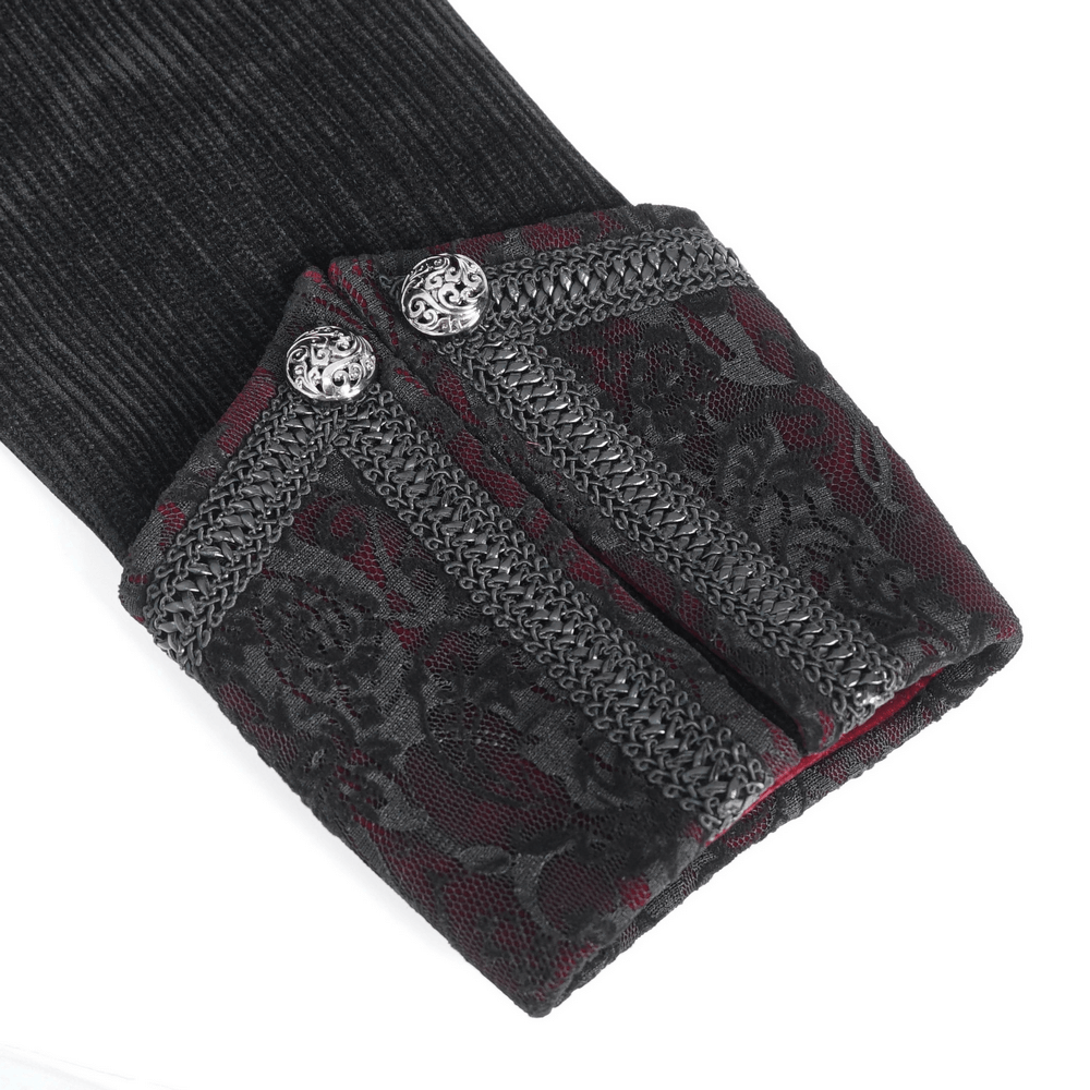 Close-up of gothic velvet tailcoat cuffs with embroidered details and ornate silver accents.