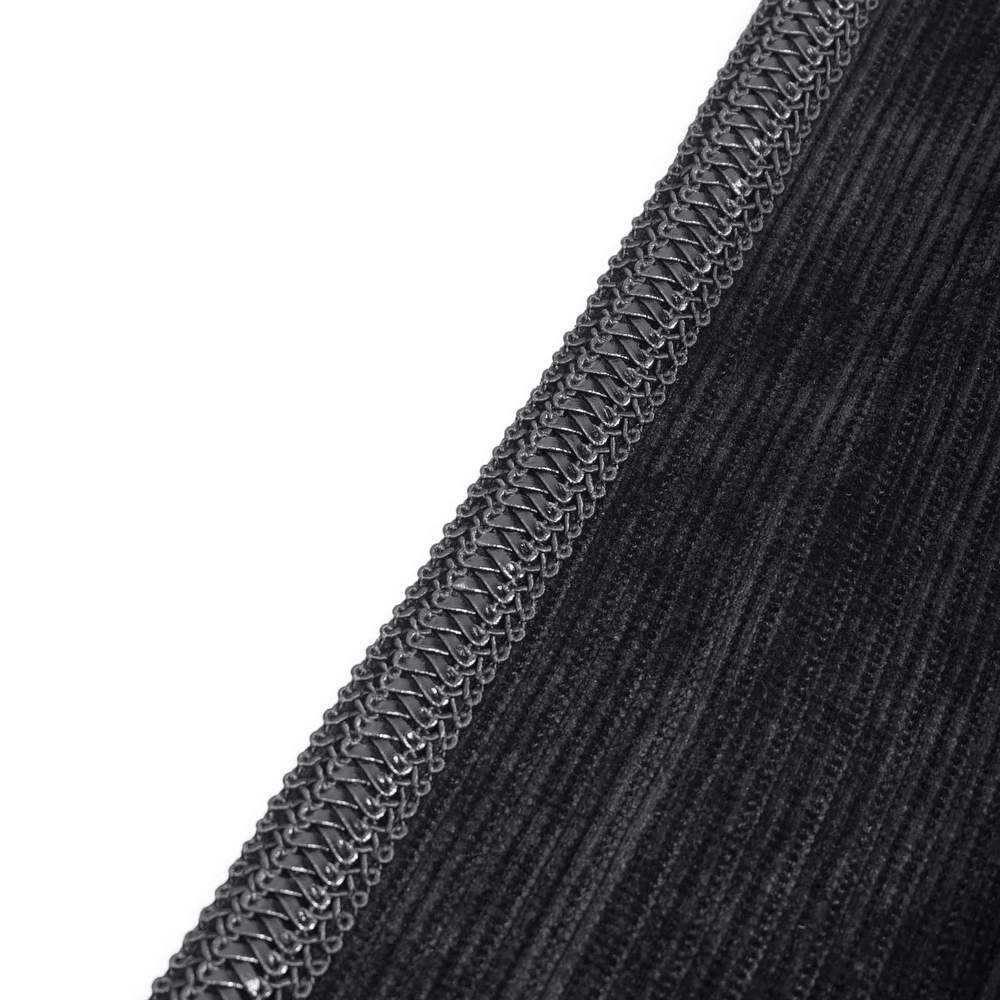 Close-up of the luxurious velvet fabric and detailed silver embroidery on a gothic tailcoat jacket.