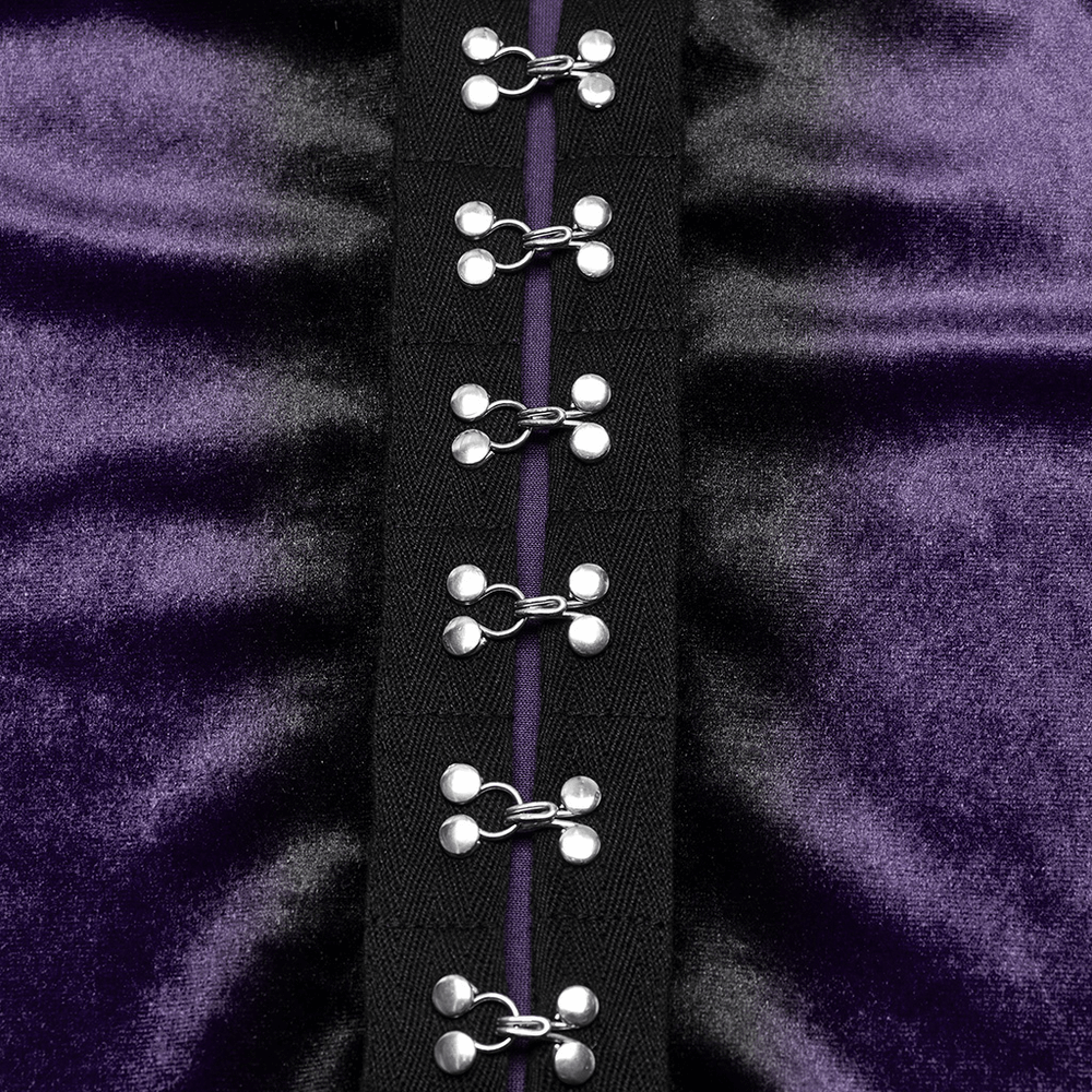 Close-up of metal buckles on gothic velvet top, showcasing an elegant and edgy design.