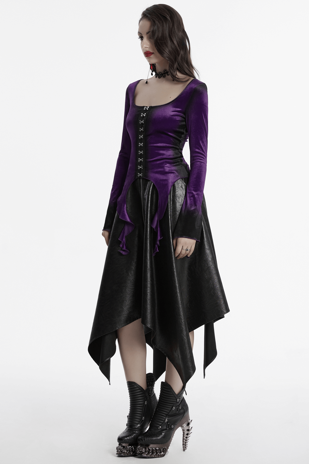 Gothic velvet top with metal buckles and dramatic hem, showcasing dark elegance and edgy style.