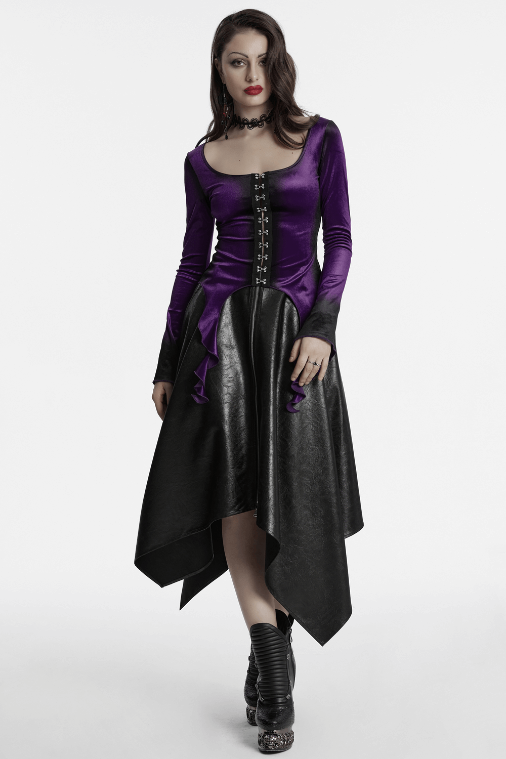 Gothic velvet top with metal buckles and dramatic hem in dark purple and black for an edgy look.