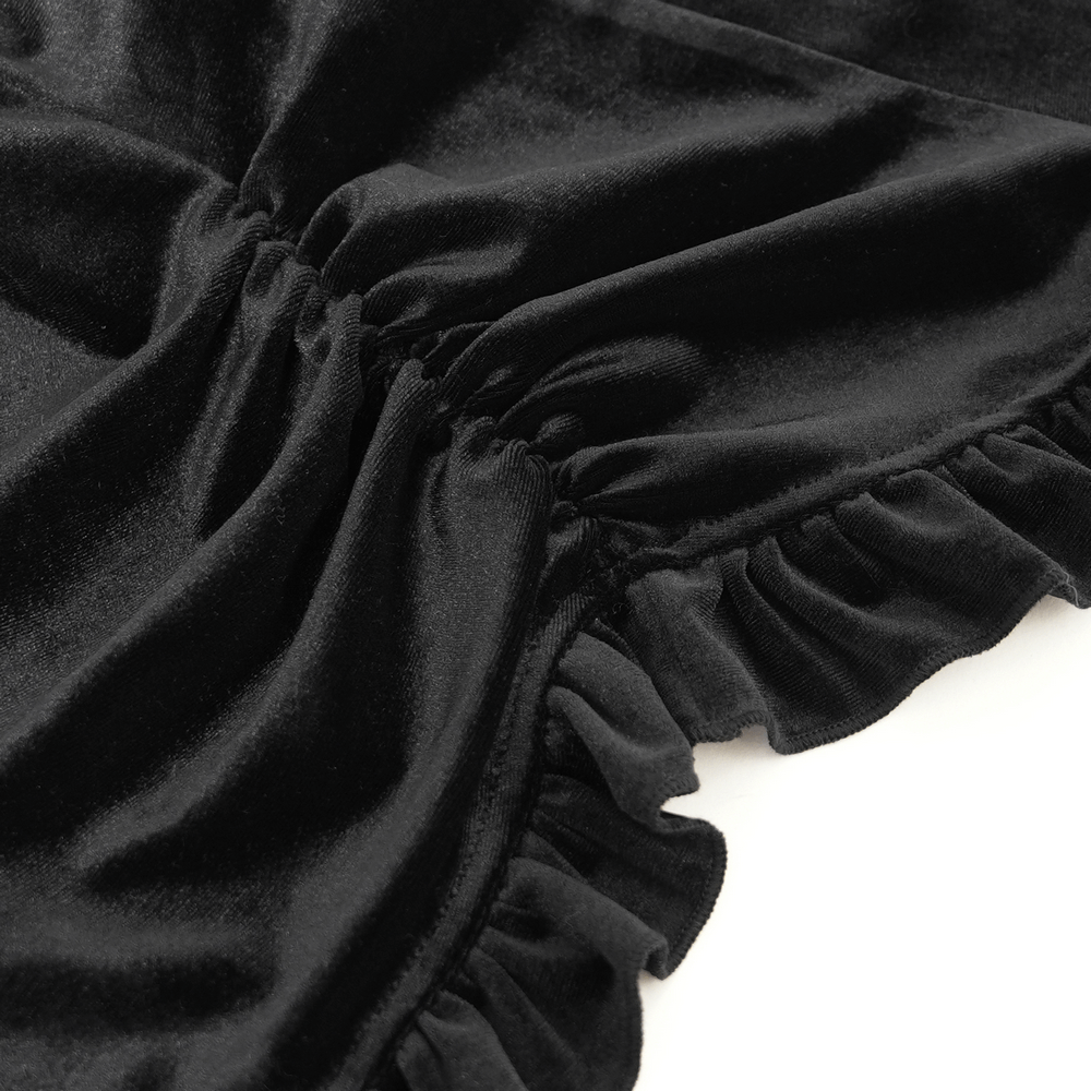 Close-up of black velvet fabric with ruffled accents, showcasing elegant texture and gothic Victorian style.