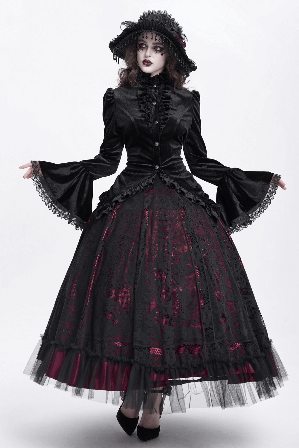 Gothic Victorian woman in black velvet blouse and layered skirt with lace accents, embodying elegant, dramatic style.