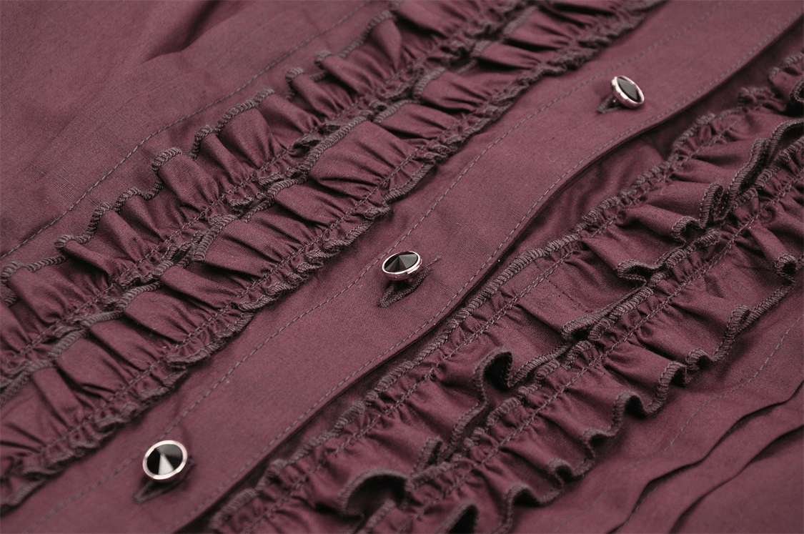 Close-up of burgundy ruffles and lace detailing on a vintage-inspired blouse.