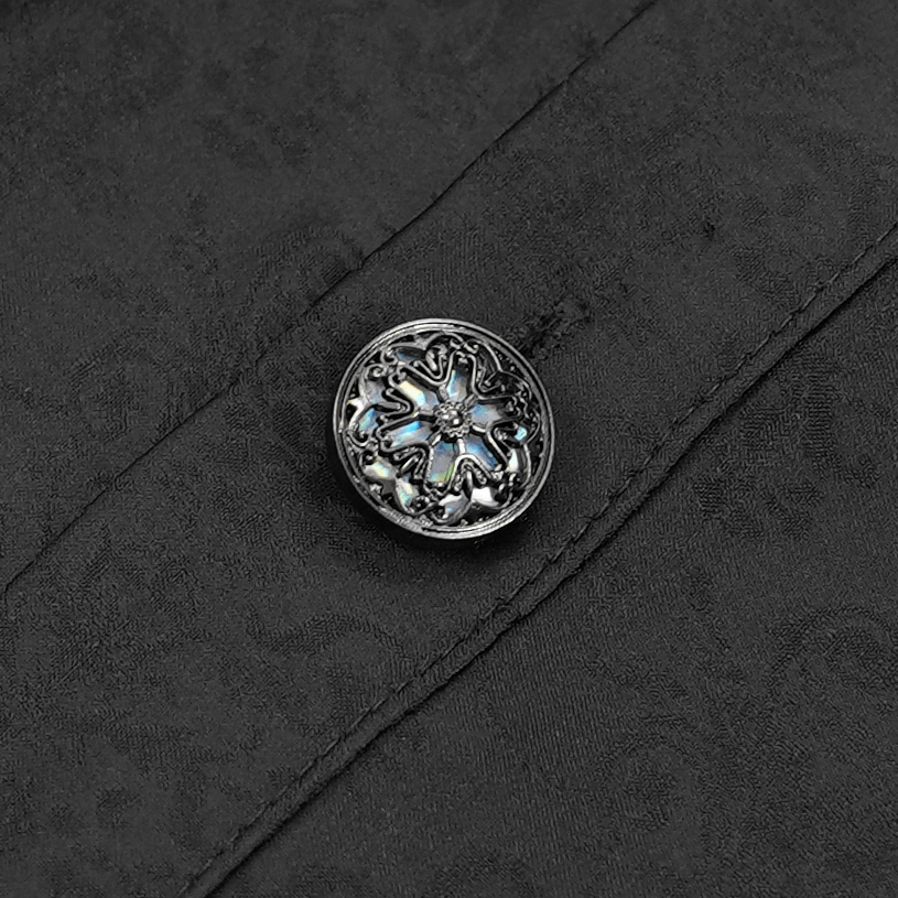 Close-up of an ornate silver button on a black Gothic Victorian shirt, adding elegance to the detailed design.