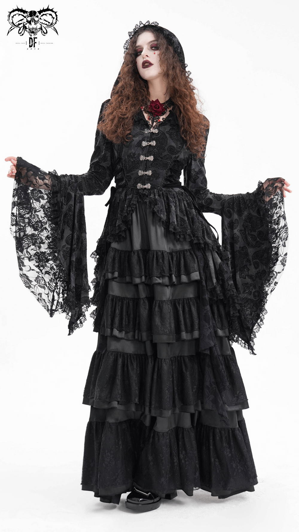 Gothic Victorian model in a black lace hooded cape with asymmetrical hem and layered skirt, exuding dark elegance.