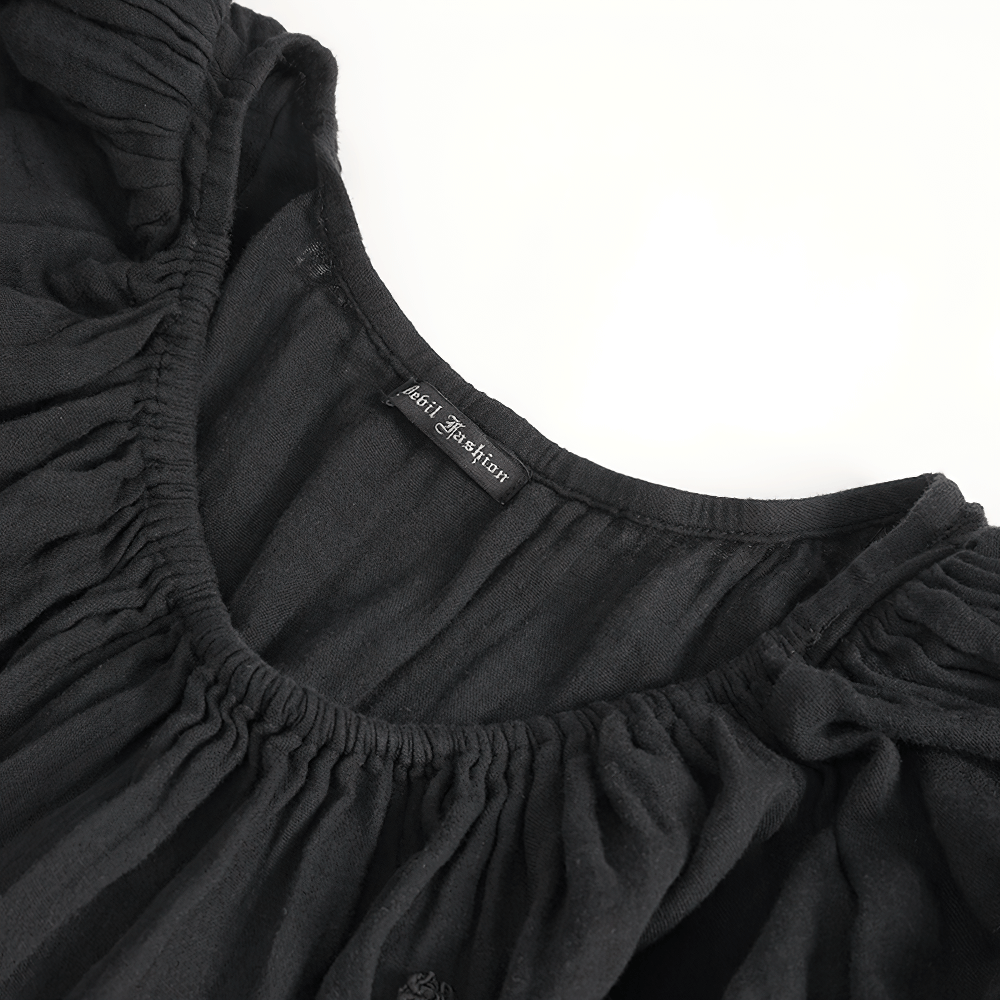 Close-up of the black Gothic Victorian dress neckline with ruched puff sleeves and brand label.