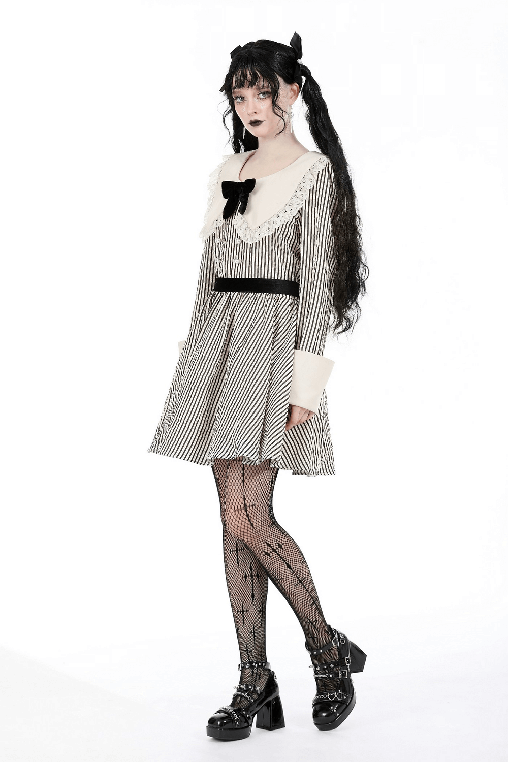 Gothic Victorian striped dress with lace collar and cuffs, paired with fishnet tights, embodying a dark princess look.