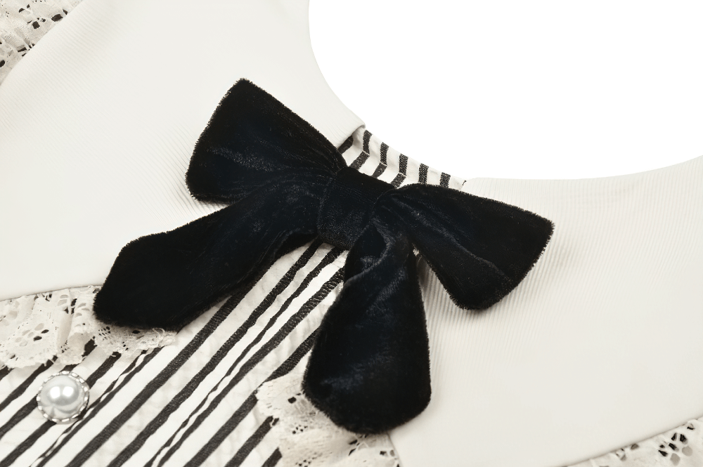 Close-up of Gothic Victorian striped dress detailing, featuring a black velvet bow and lace trim.