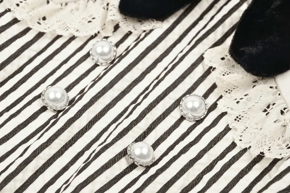 Close-up of Gothic Victorian striped dress with lace collar, cuffs, and pearl buttons.