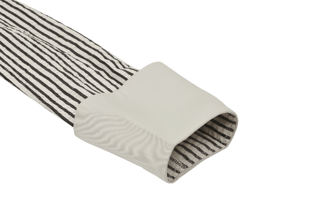 Close-up of the lace cuff on a Gothic Victorian striped dress, showcasing black and white stripes and delicate lace.