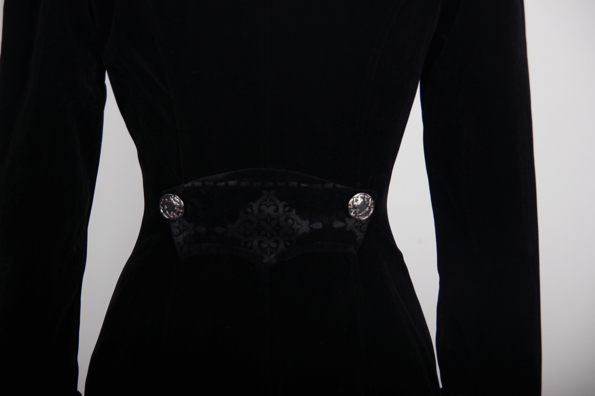 Close-up of the fitted waist of a Gothic vintage black trench coat with decorative buttons and steampunk embroidery.