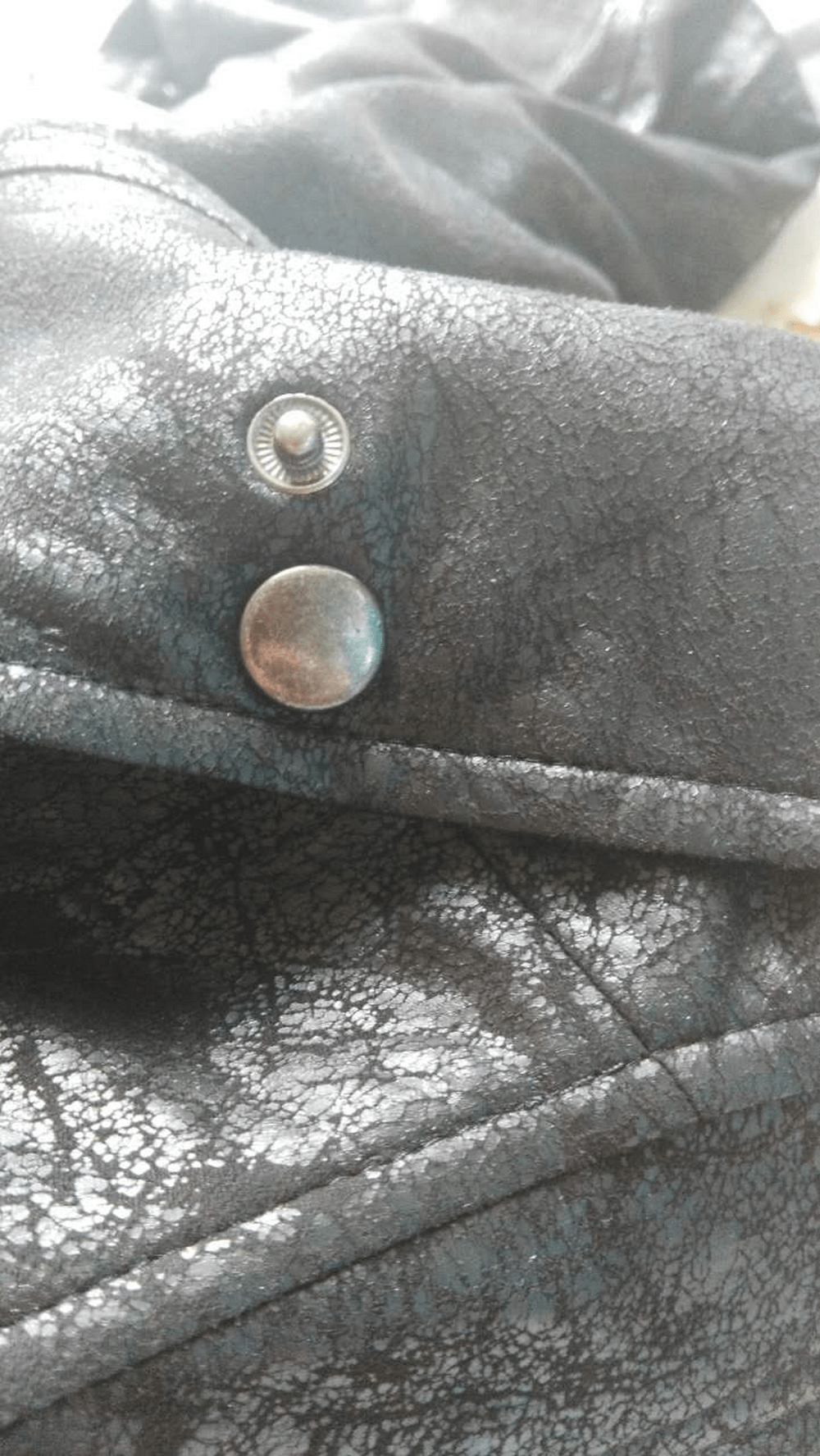 Close-up of a stylish Gothic vintage black coat button detail, showcasing the quality PU leather texture.