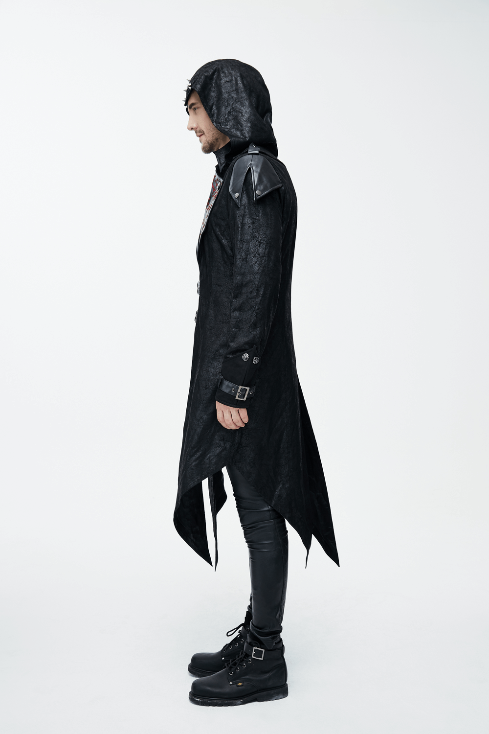 Side view of a man in a gothic vintage long black men's coat with hood and stylish details.