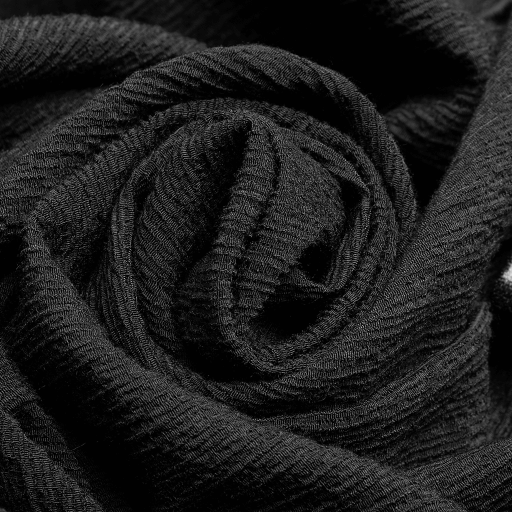 Close-up of black textured fabric in a rose shape, showcasing its soft and luxurious textile quality.