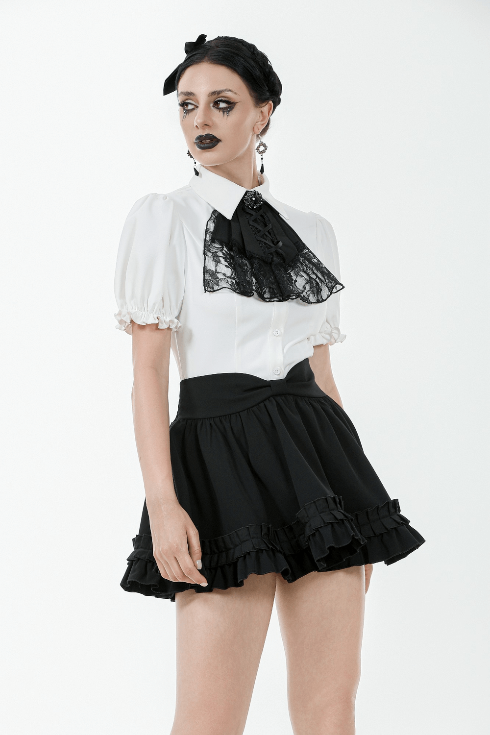Gothic white blouse with detachable lace jabot, corset detail, and puff sleeves styled with a black ruffled skirt.