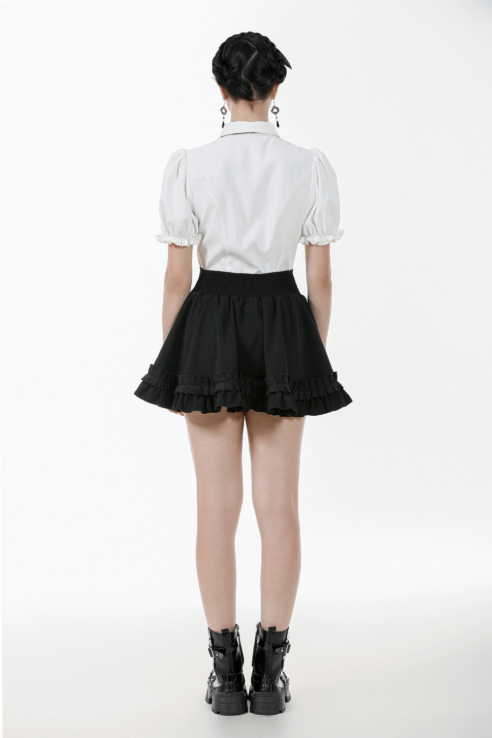 Back view of gothic white blouse with puff sleeves, styled with a black skirt and chunky boots.