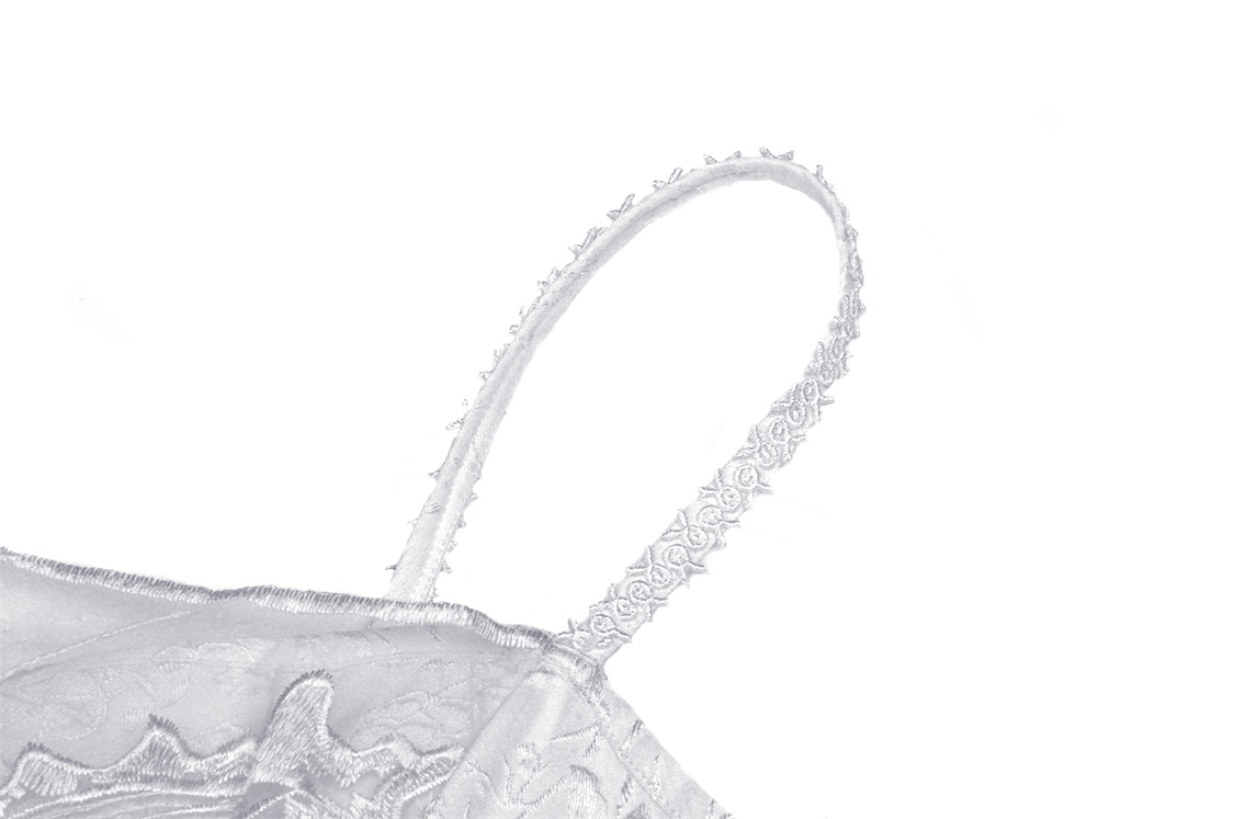 Close-up of delicate strap on a Gothic white butterfly dress featuring intricate lace details.
