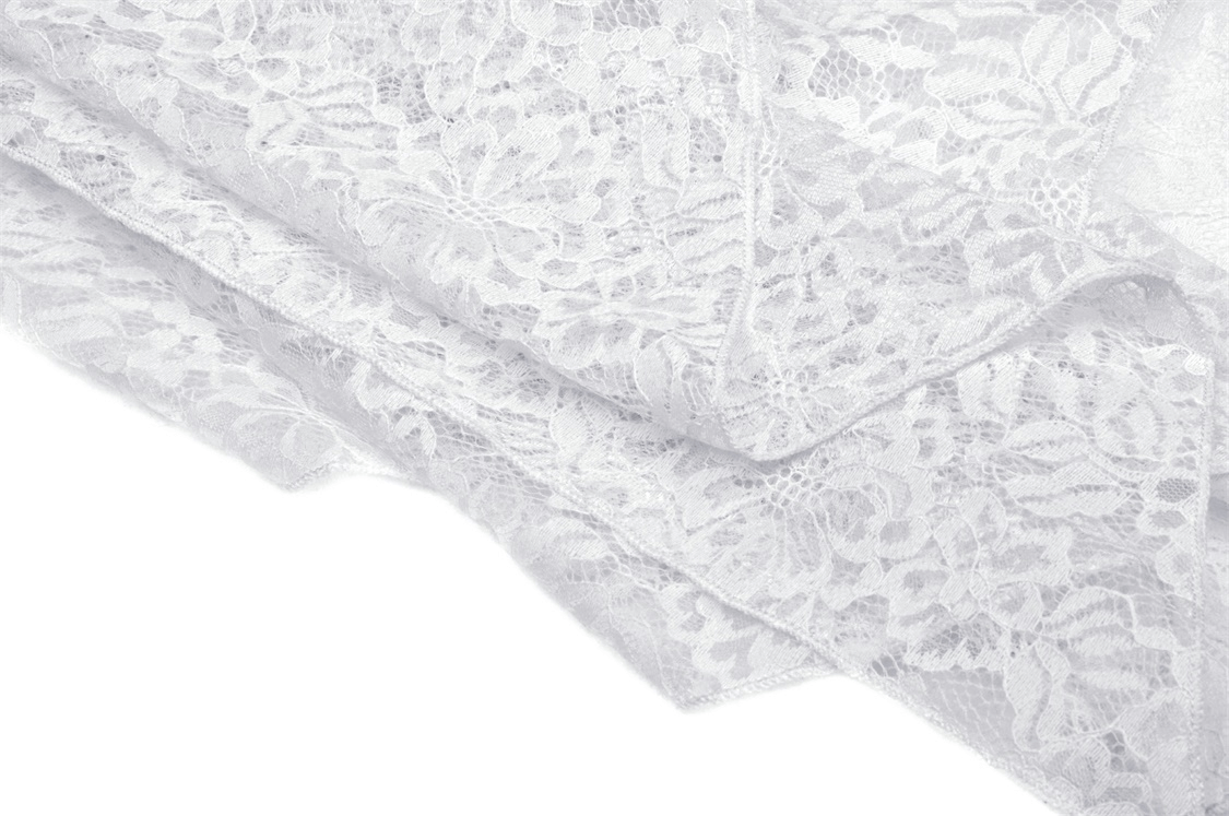 Delicate white lace fabric showcasing intricate floral patterns, perfect for gothic or romantic designs.