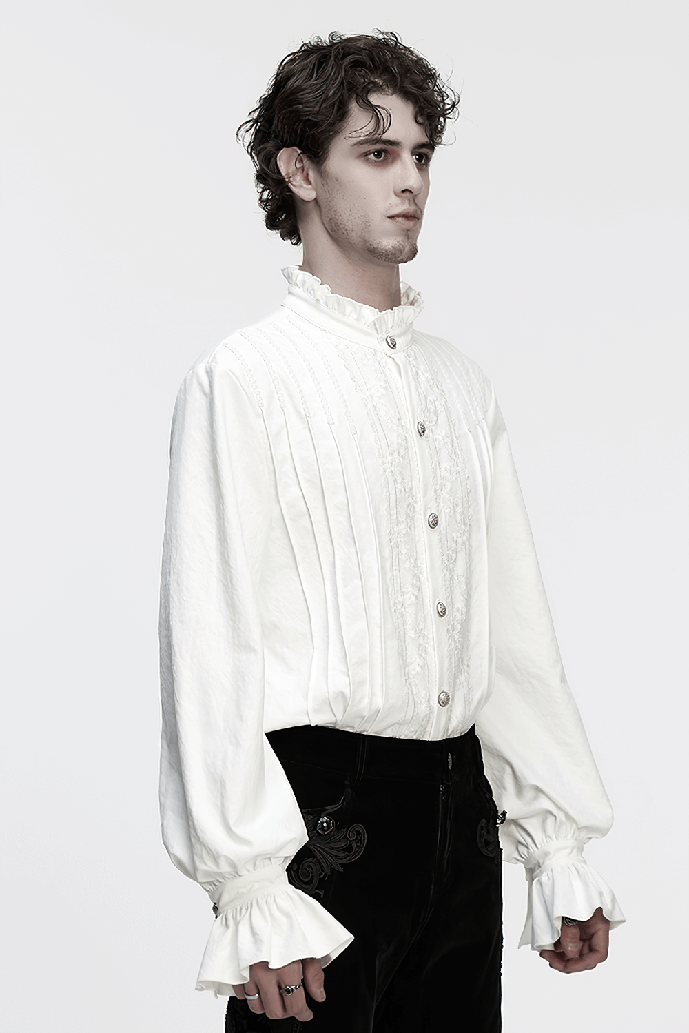 Gothic White Ruffled Long Sleeve Shirt with Lace Details worn by model, featuring 3D pleating and ruffled sleeves.