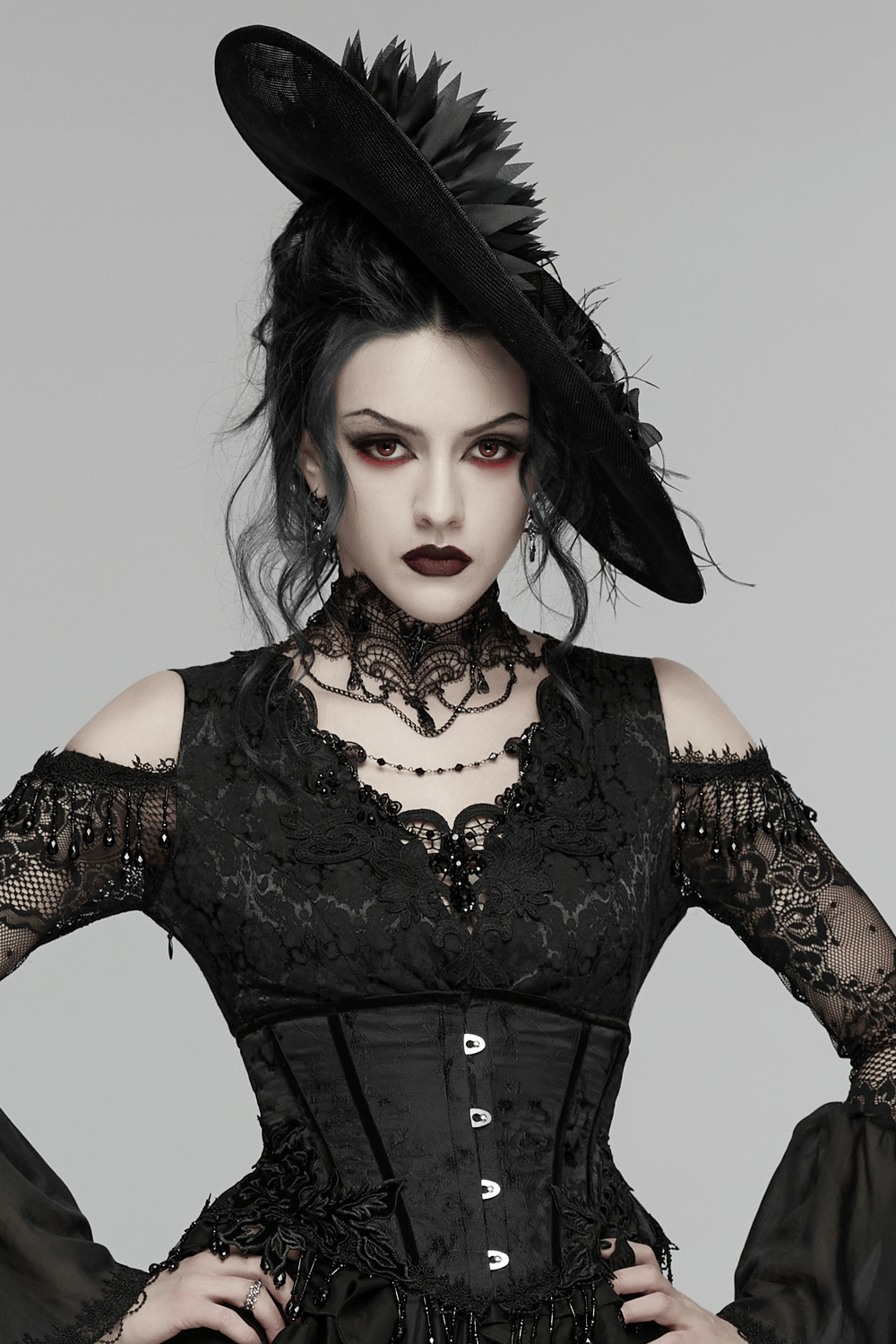 Gothic Wide Brim Feather Fascinator Hat in Black worn by a model in a dramatic gothic outfit.